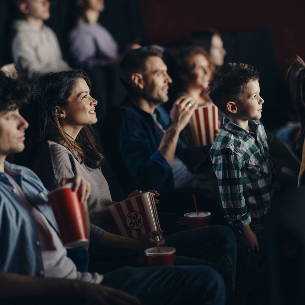 Family watching theatre together